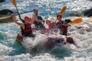Happy people on rafting on Soča river